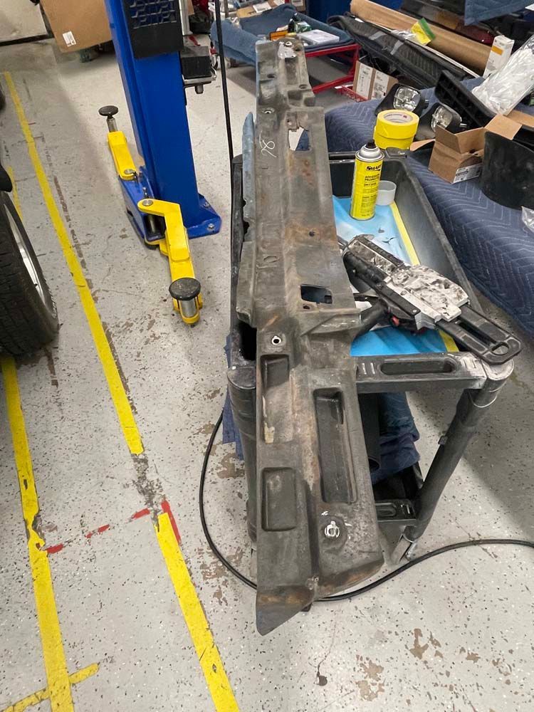 A piece of metal is sitting on a table in a garage.