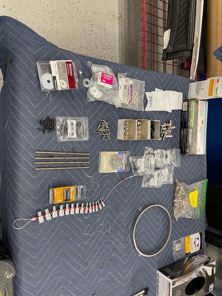 A bunch of tools are sitting on top of a blue blanket.