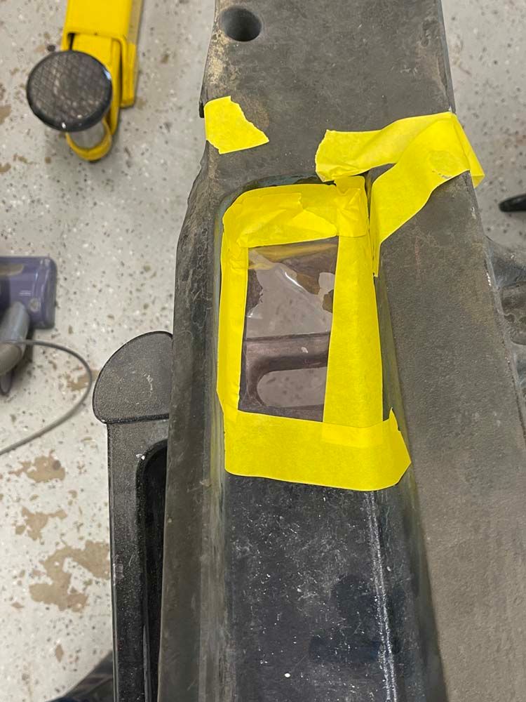 A piece of metal with yellow tape on it