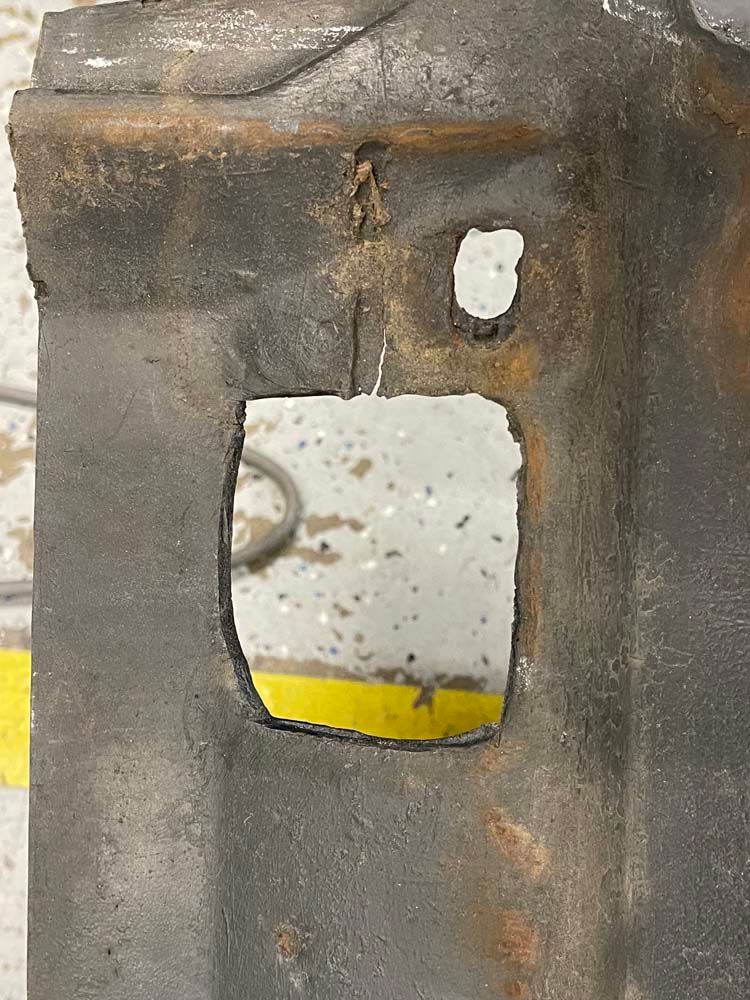 A close up of a piece of metal with a hole in it.