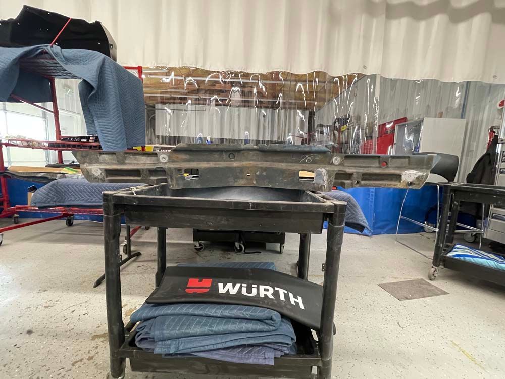 A cart with a wurth logo on it is in a garage.