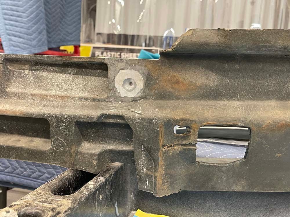 A piece of metal with a hole in it is sitting on a table.