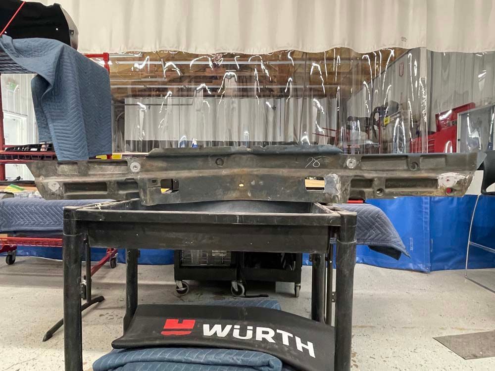 A bumper is sitting on top of a table in a garage.
