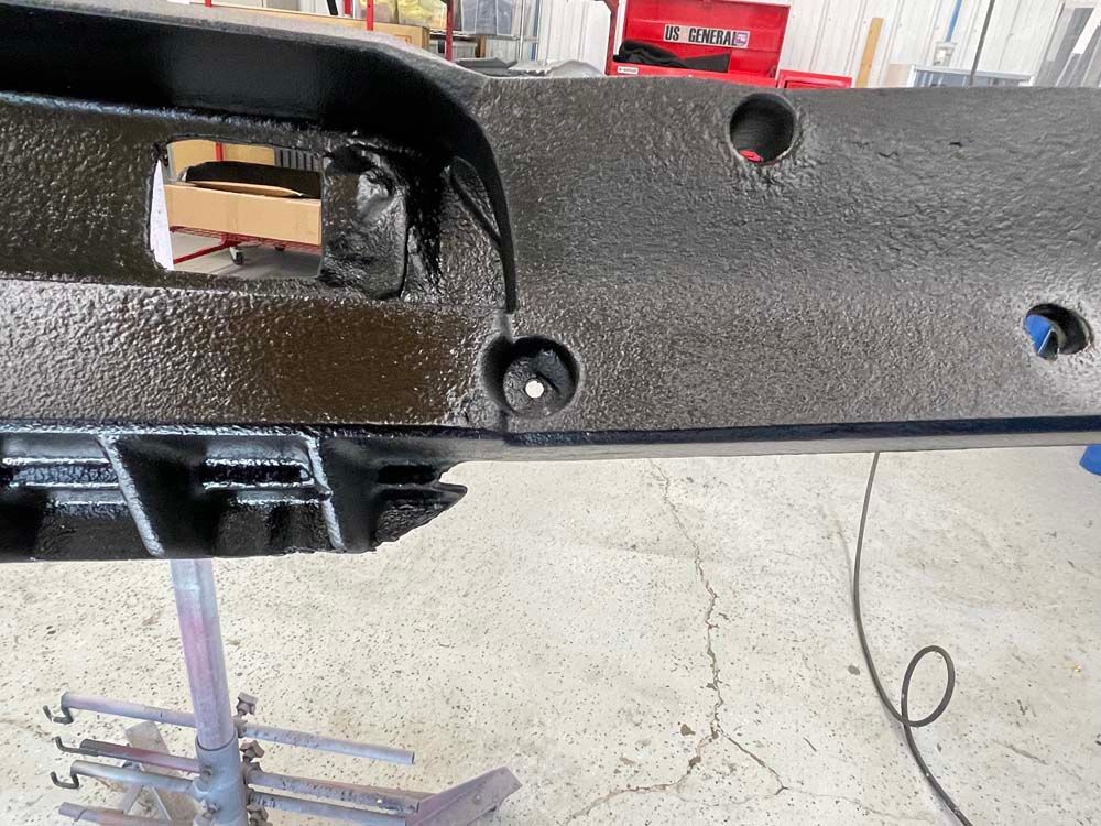 A piece of metal with holes in it is sitting on a table.