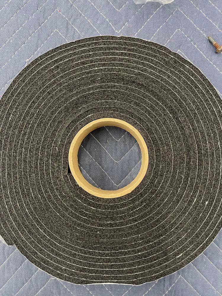A roll of foam tape with a hole in the middle is sitting on a table.