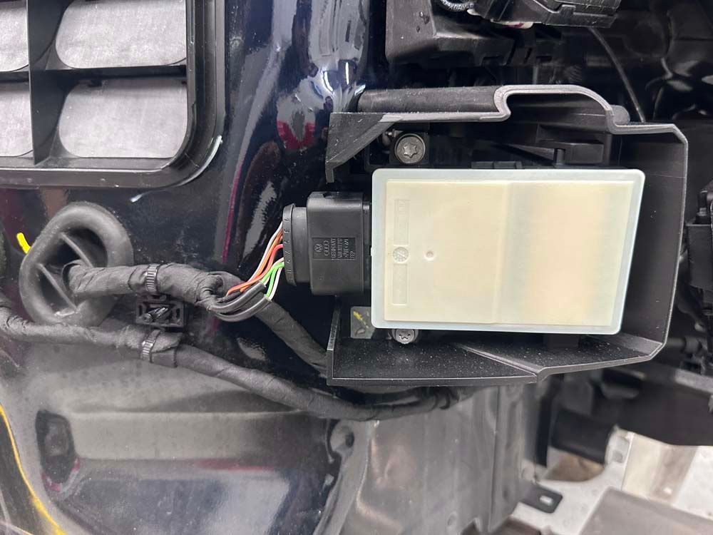 A close up of a sensor on the side of a car.