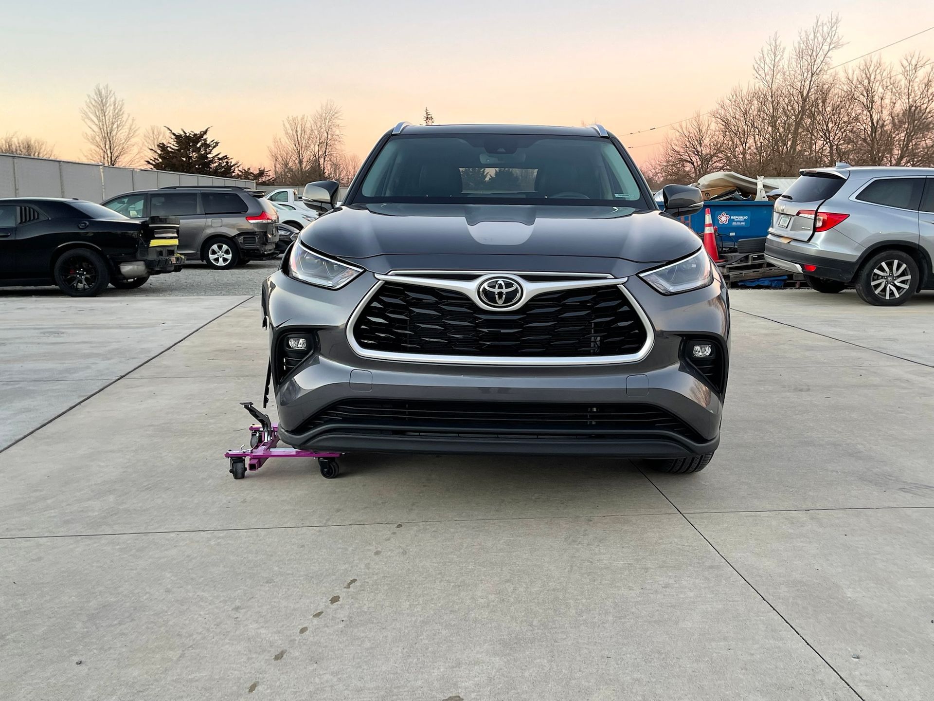 A toyota highlander is parked in a parking lot.