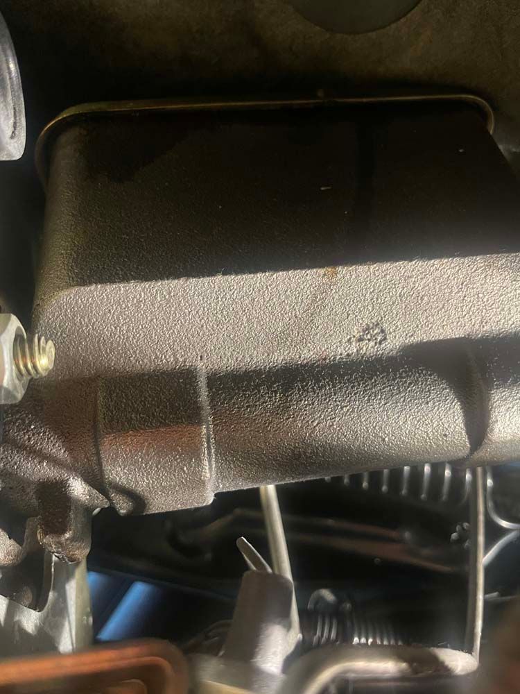 A close up of a metal object in a car engine.