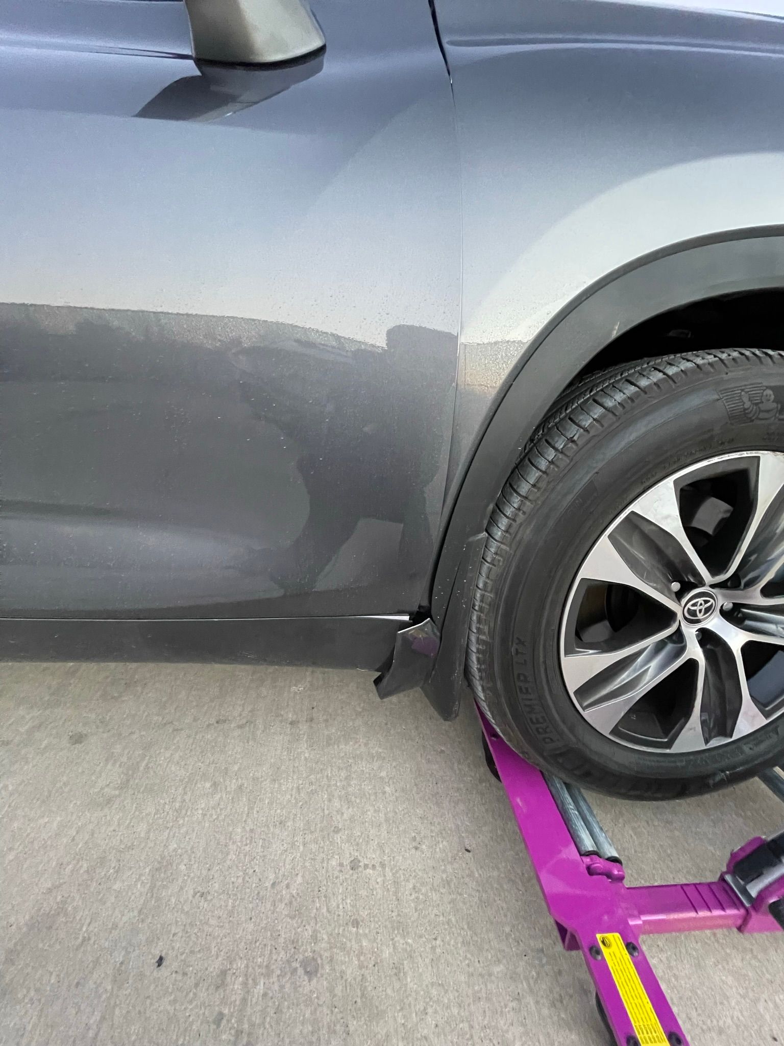 A car is being towed by a tow truck.