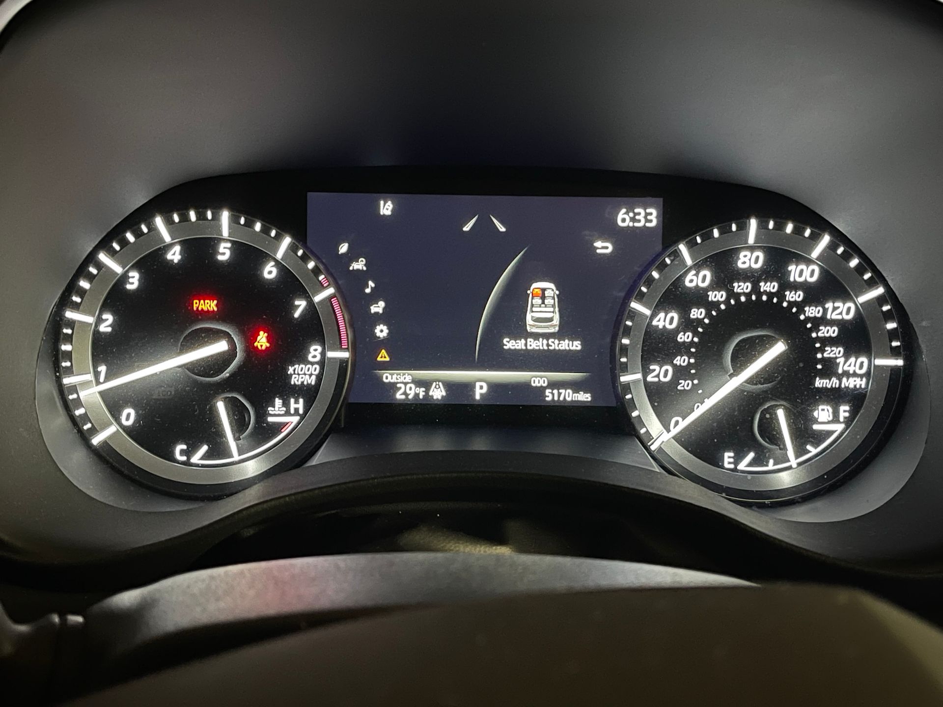 A close up of a car dashboard with a clock on it