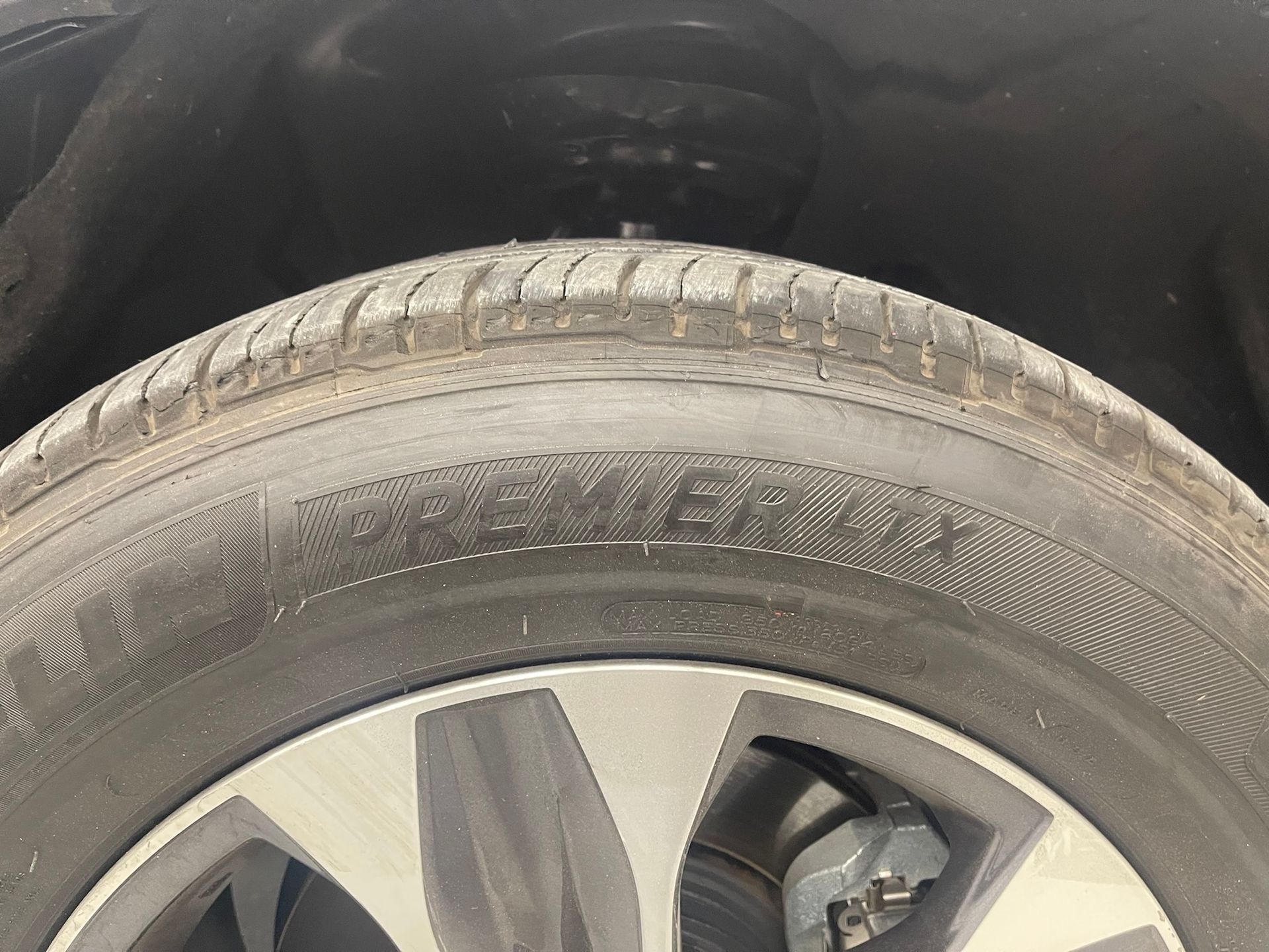A close up of a tire on a car wheel.