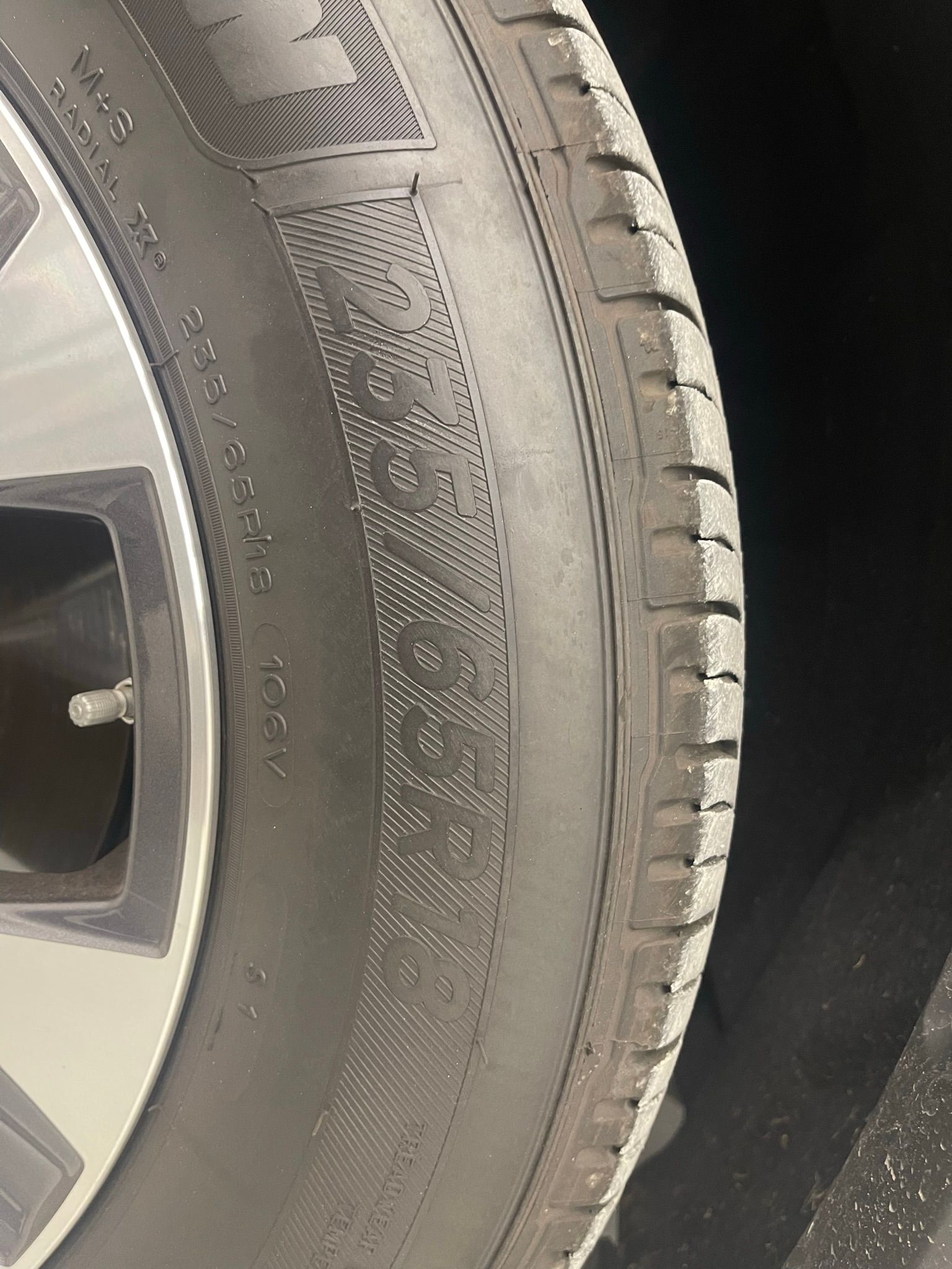A close up of a tire on a car wheel.