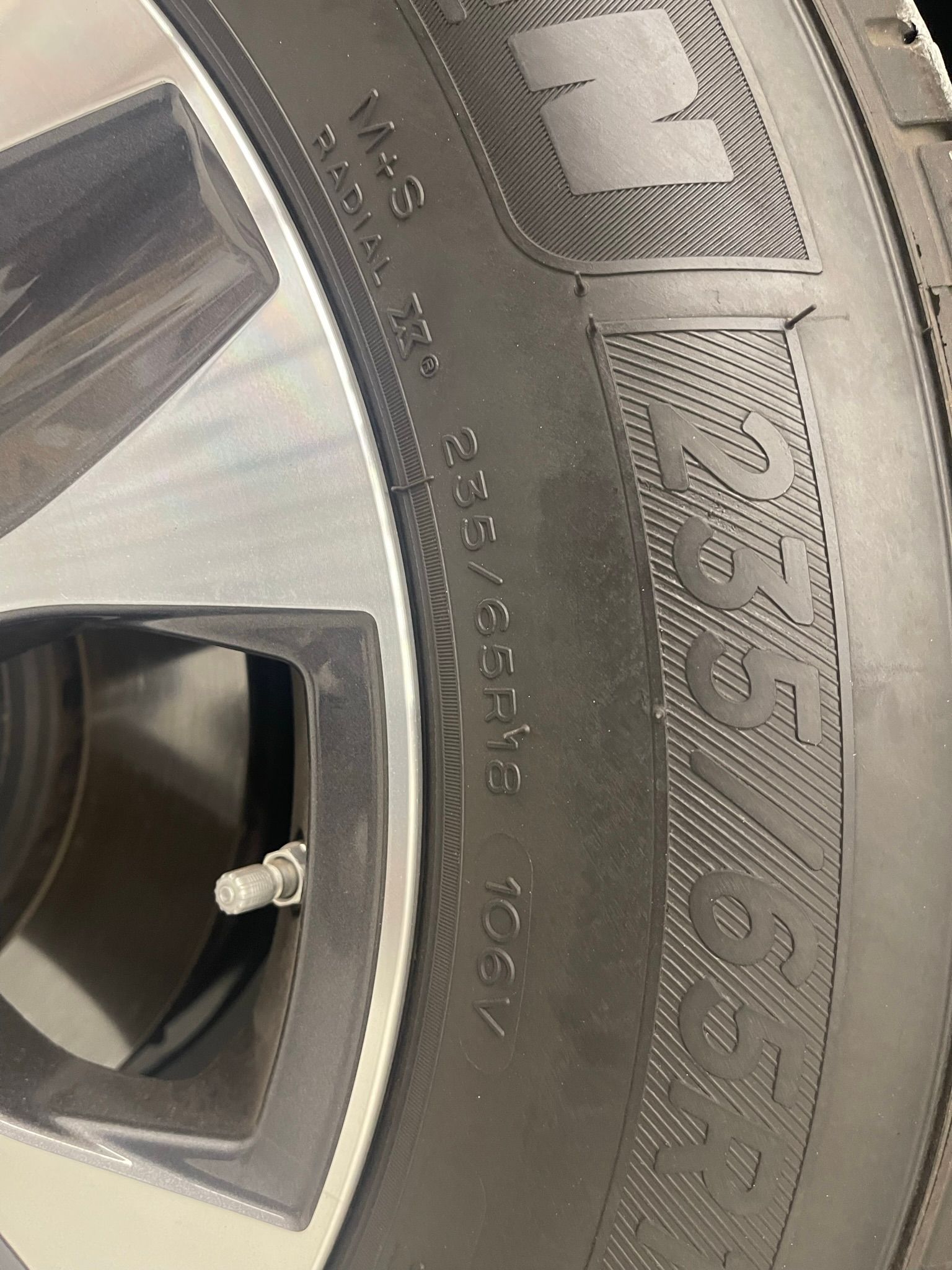 A close up of a tire on a car wheel