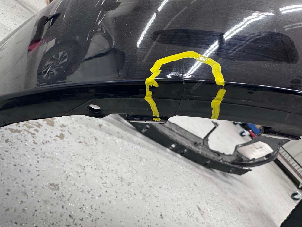 A close up of a car hood with a yellow circle on it