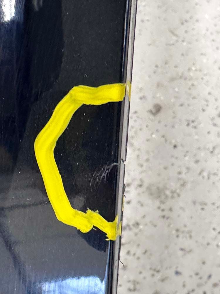 A yellow c is painted on the side of a car