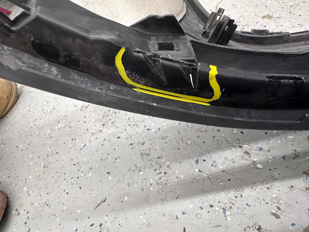 A close up of a bumper with a yellow line on it.