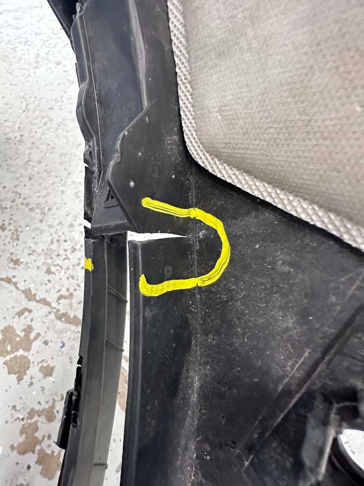 A close up of a car door with a yellow u on it.