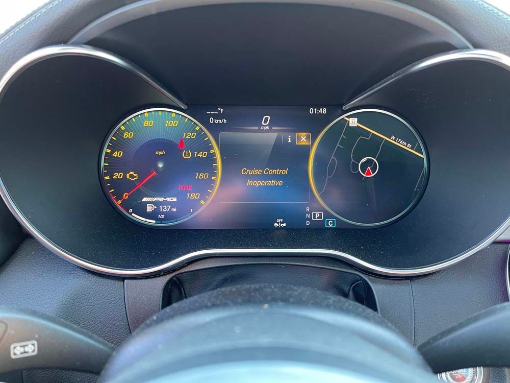 A close up of a car dashboard with a steering wheel.