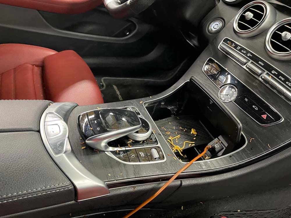 The dashboard of a car with a cord plugged into it