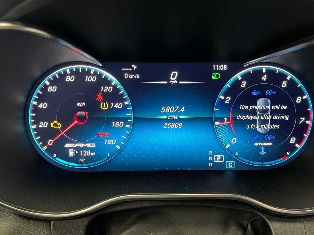 A close up of a car dashboard with a speedometer and a tachometer