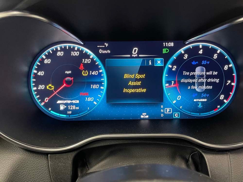 A close up of a car dashboard with a screen that says disc spot assist