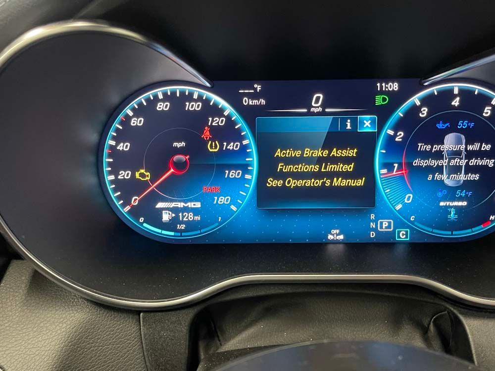 A close up of a car dashboard with a screen that says active brake assist