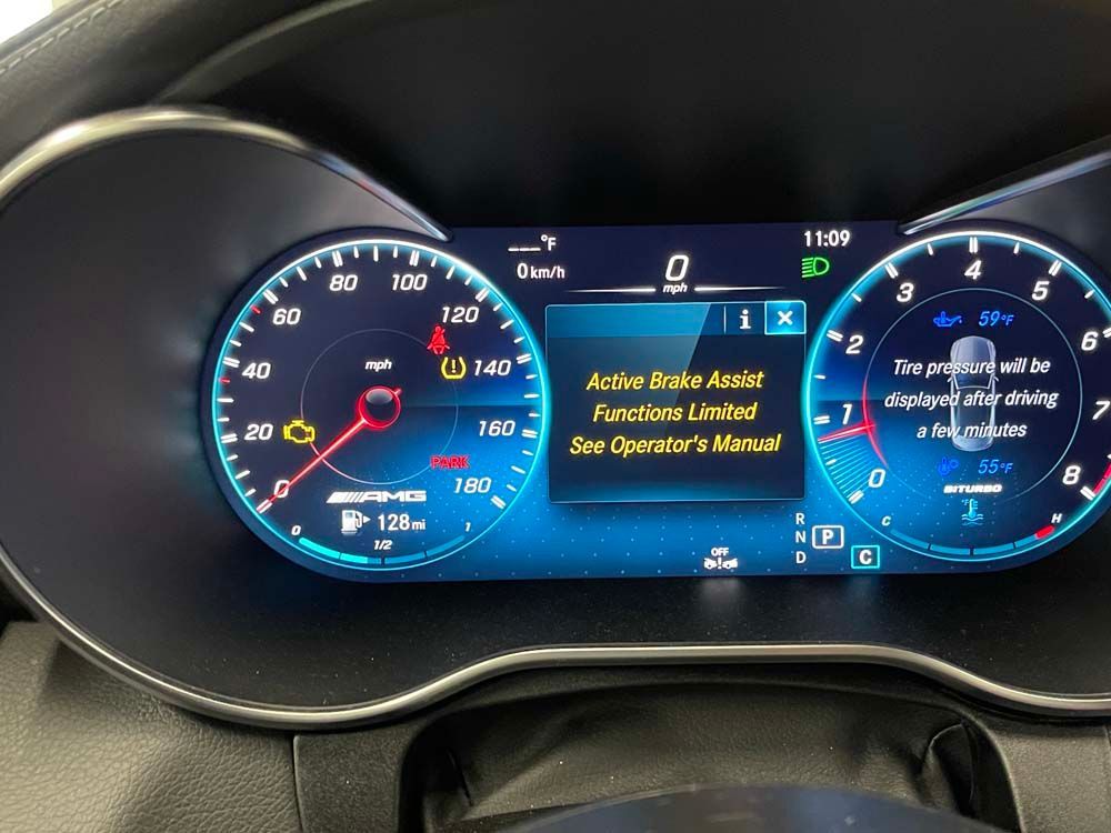 A car dashboard with a screen that says active brake assist