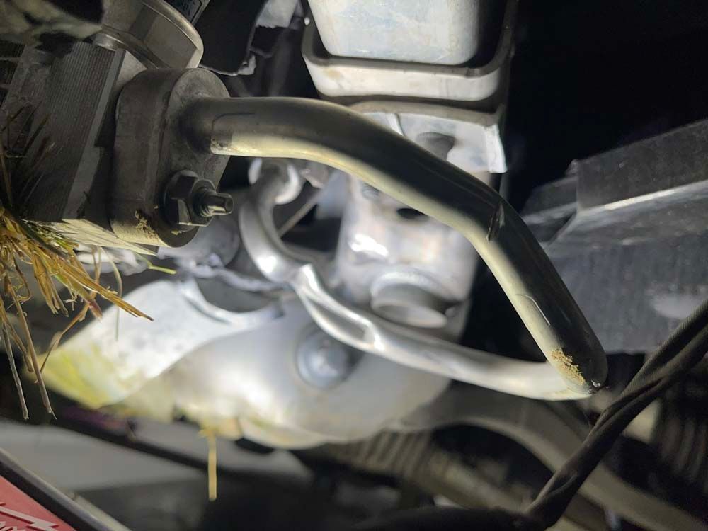 A close up of a hose on the side of a car