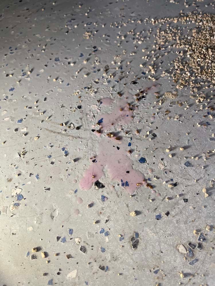 A concrete floor with a lot of small rocks on it