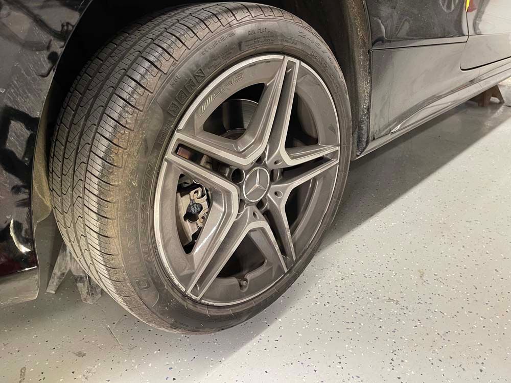 A close up of a car wheel with a tire on it.