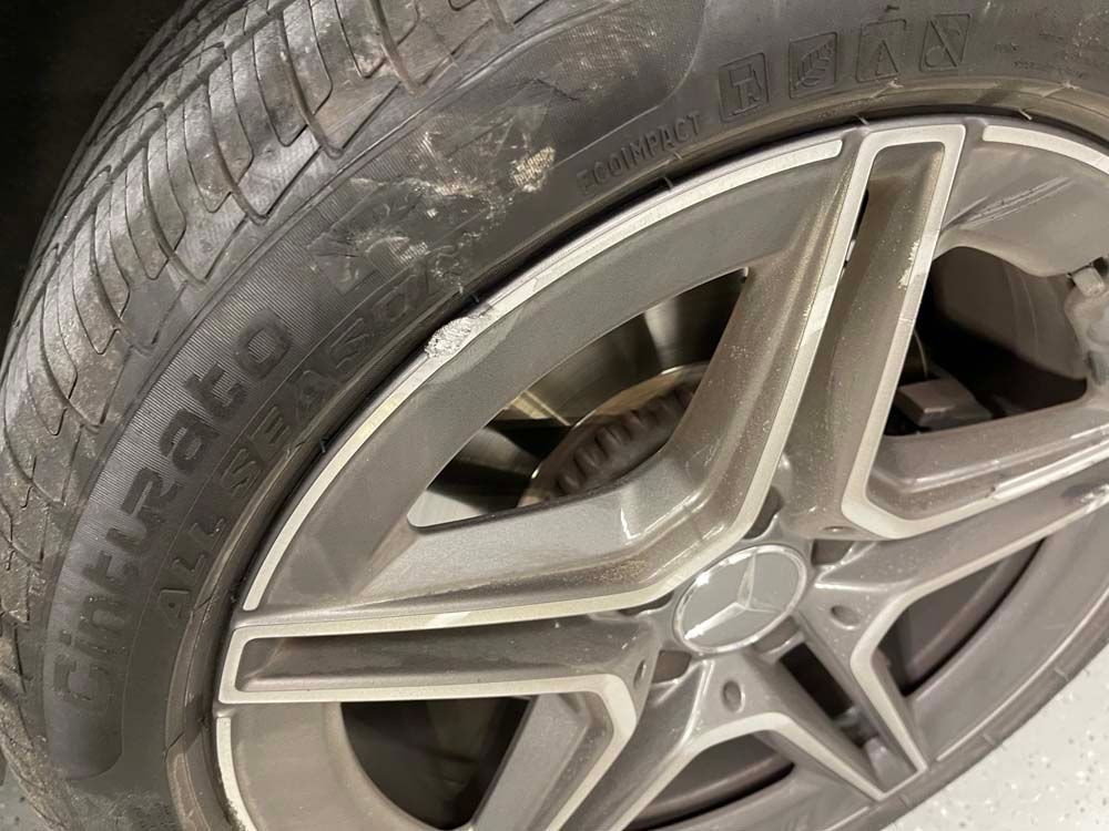 A close up of a tire on a car wheel.