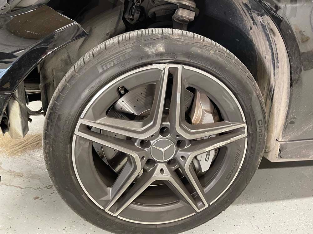 A close up of a car wheel with a tire on it.