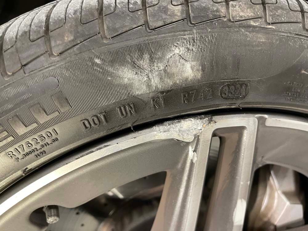 A close up of a tire on a car wheel.