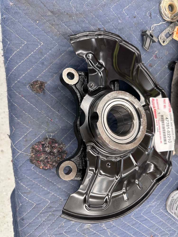 A close up of a bearing on a piece of metal on a table.