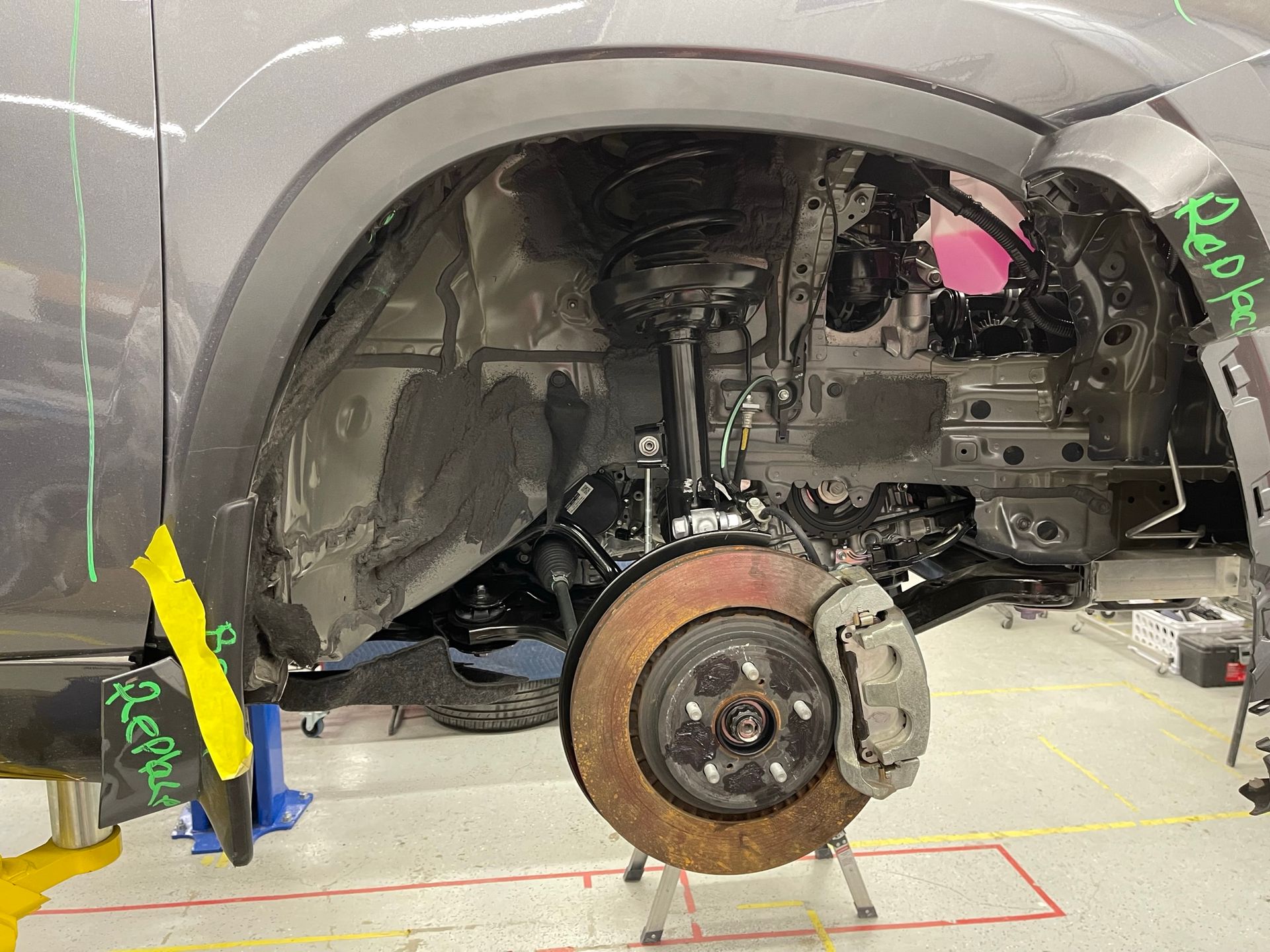 A car is being worked on in a garage.