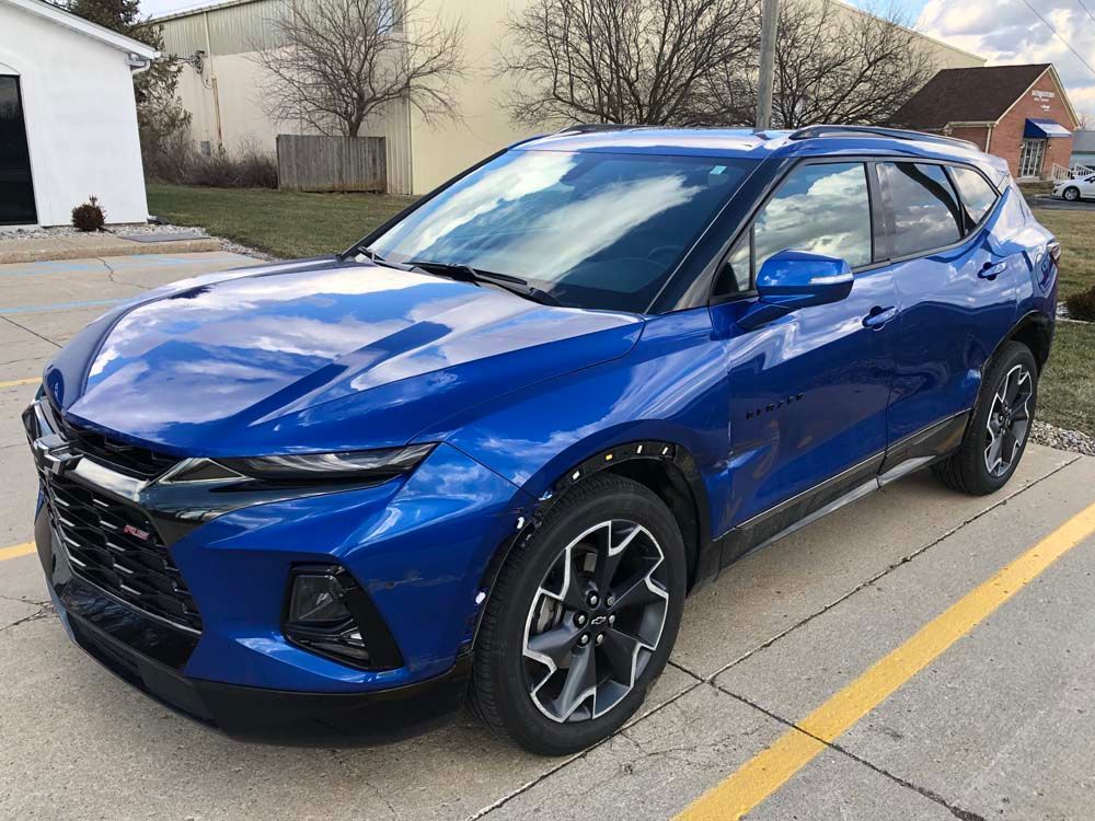 Blue Chevrolet Blazer SUV parked outside.