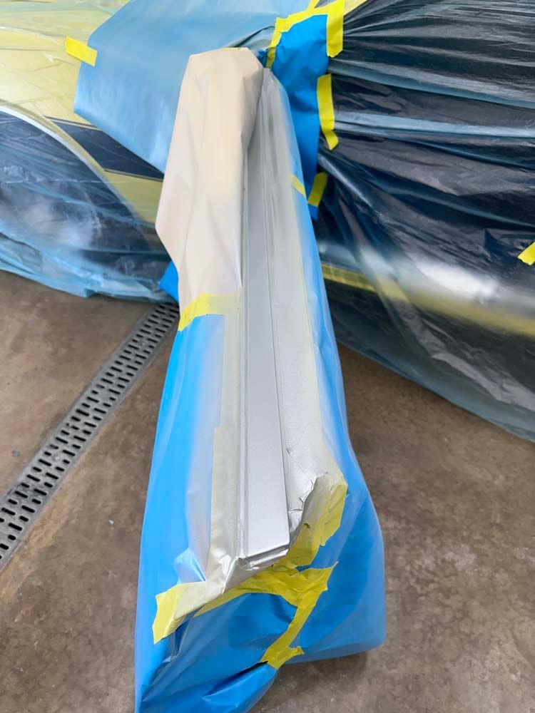 A piece of foam is wrapped in a blue plastic bag