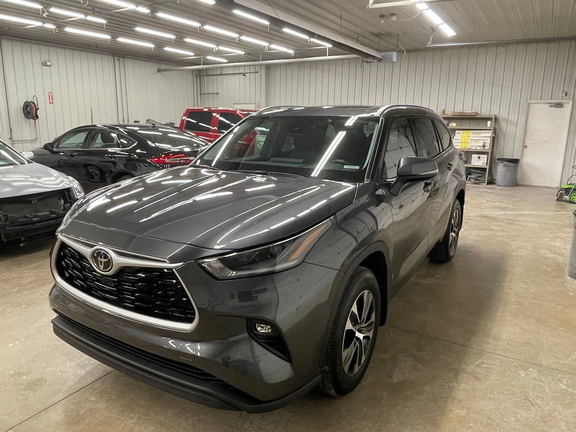 Gray Toyota Highlander SUV parked inside a garage.