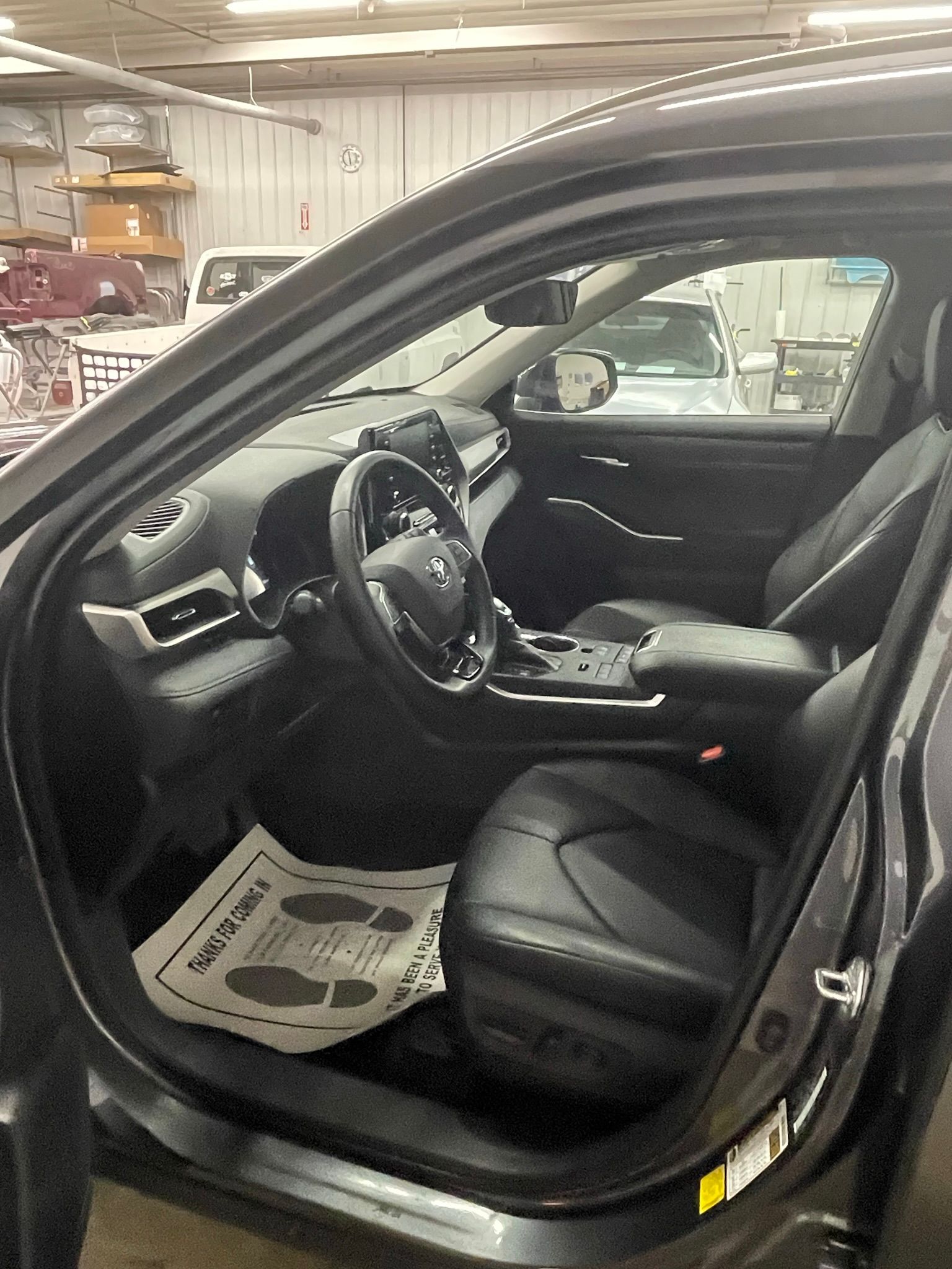 The inside of a car is shown with the door open.