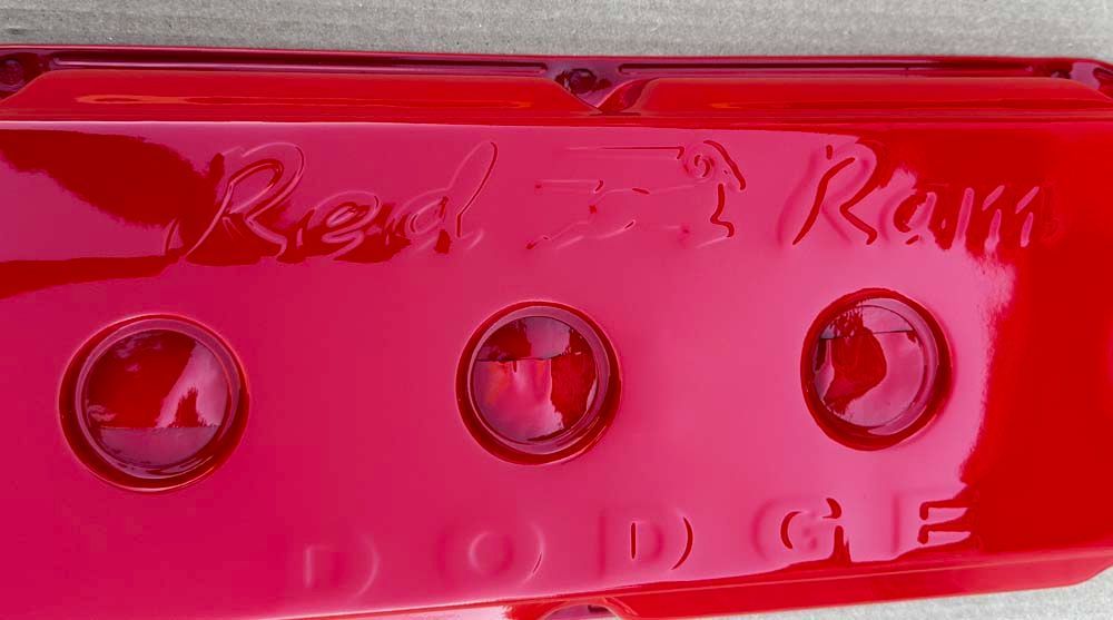 A close up of a red item that says dodge on it