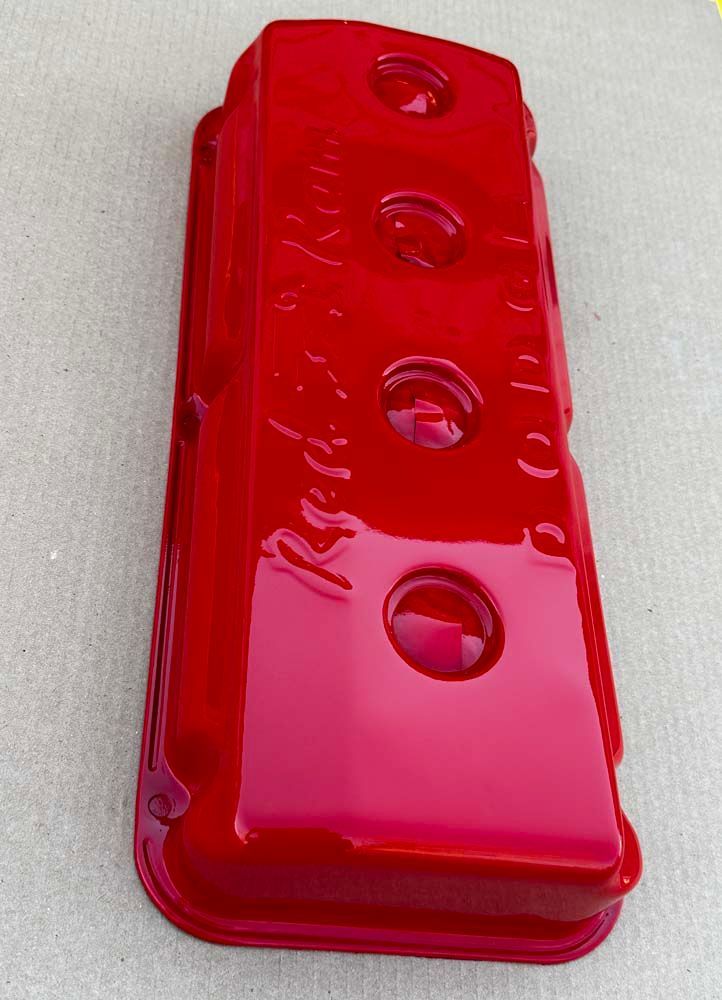 A red valve cover with the word red on it
