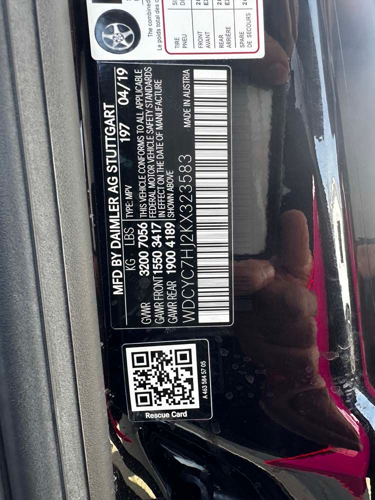 A person is holding a black car with a barcode on it.