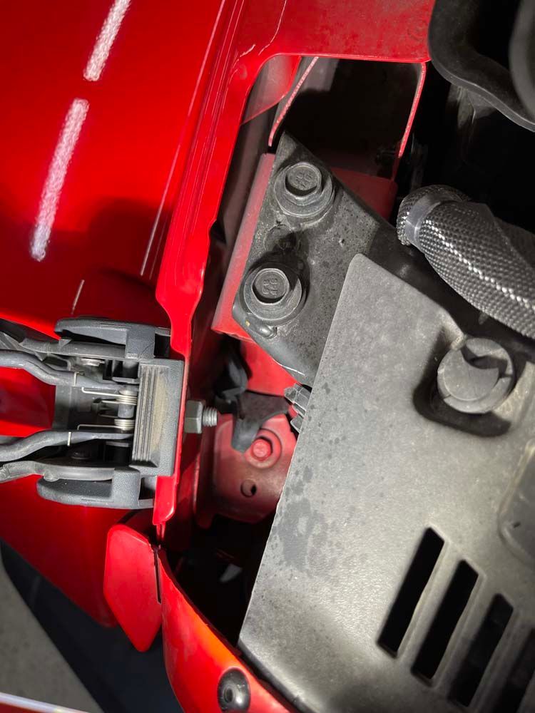 A close up of a red car with the hood open