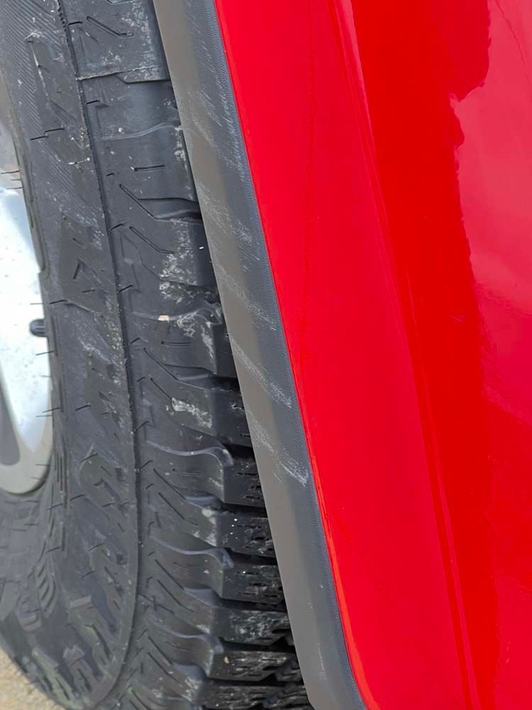 A close up of a tire on a red car