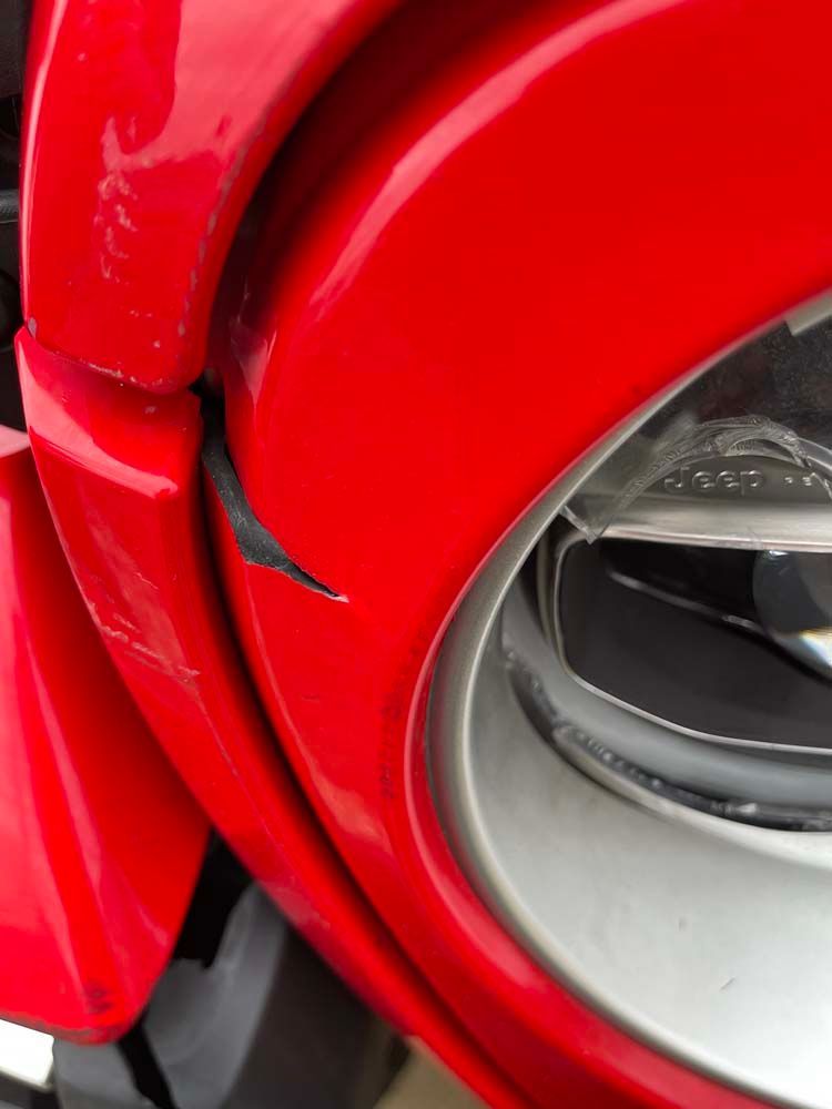 A close up of a red motorcycle headlight