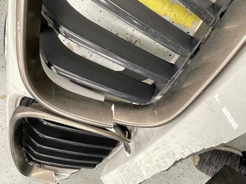 A close up of a broken bumper on a car.