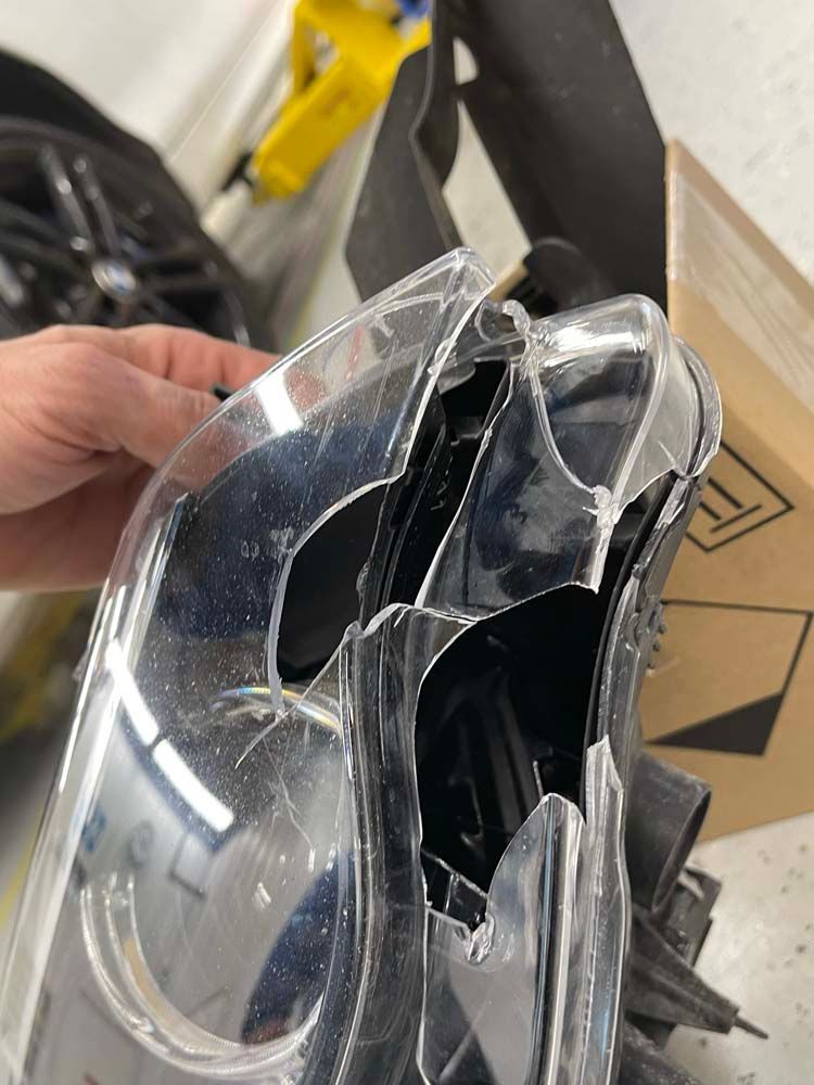 A person is holding a broken plastic object in their hand.