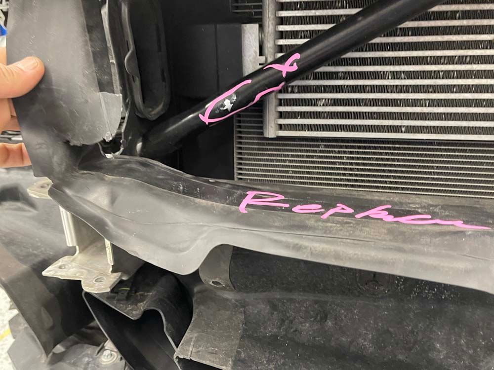 A close up of a person holding a piece of metal with the word repka written on it