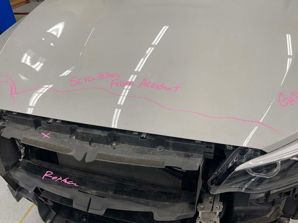 A close up of a car with the hood removed.
