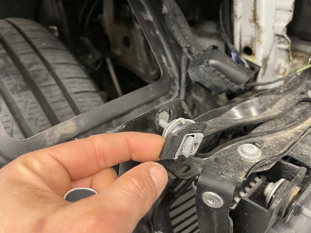 A person is holding a piece of metal in their hand.